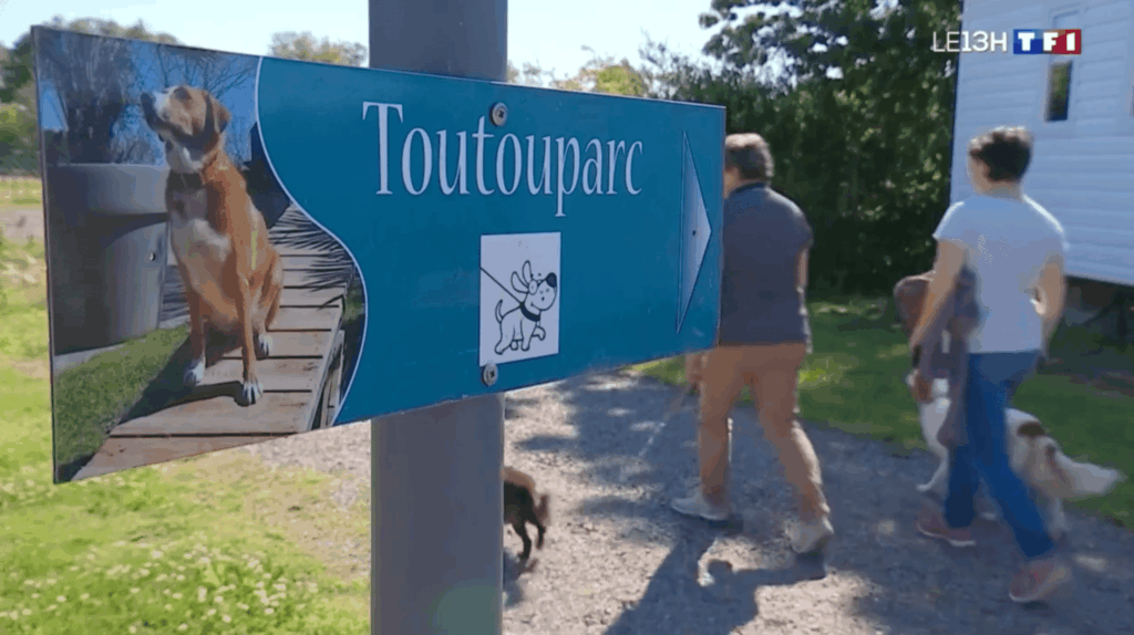Panneau Toutouparc avec des promeneurs et chiens